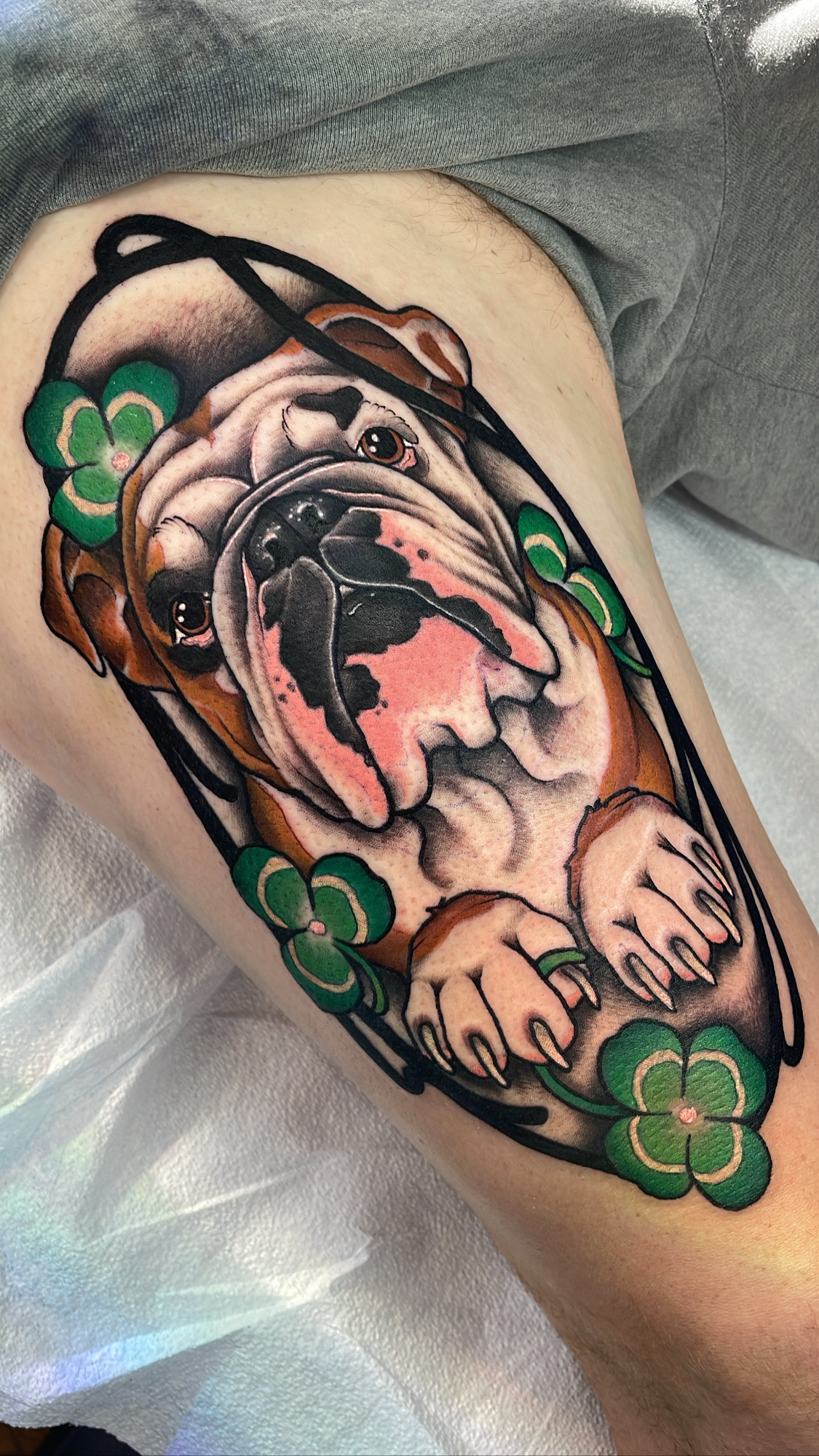 Bulldog with shamrocks, neo traditional thigh tattoo by Mariella